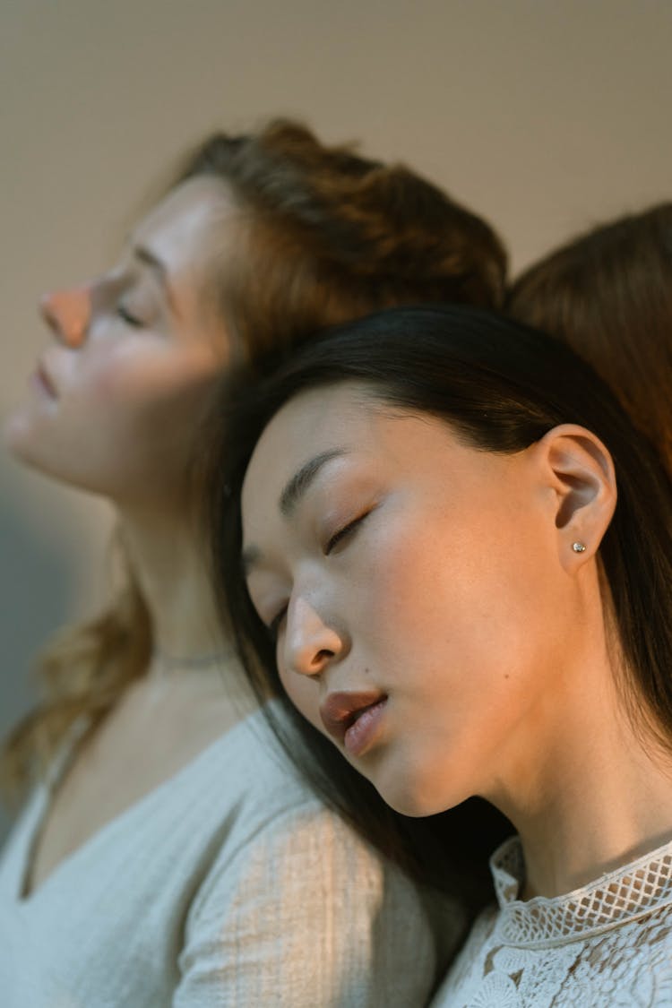 A Woman Sleeping While Leaning Her Head On The Person's Shoulder 