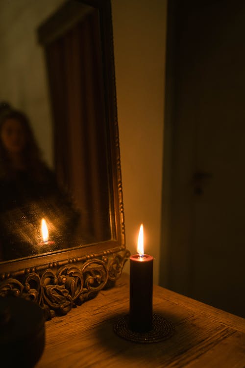 Free White Lighted Candle Near the Mirror  Stock Photo