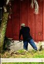 Back View Shot of a Man Cutting the Grasses