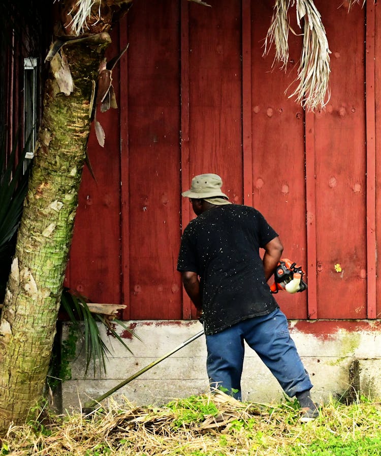 A Man Using Grass Cutter