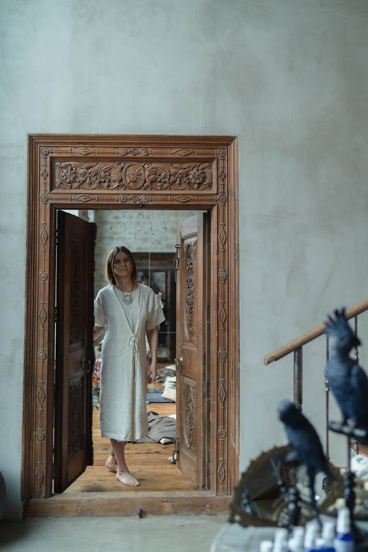 A Woman Standing By A Doorway