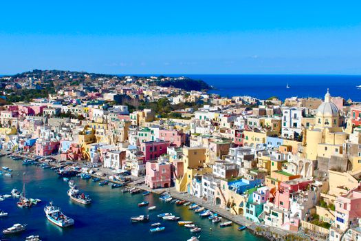 Aerial View of Pastel Colored Buildings Near Body of Water
