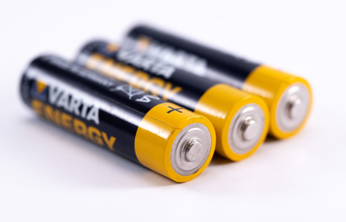 High-quality image showcasing a close-up view of three alkaline batteries on a white surface.