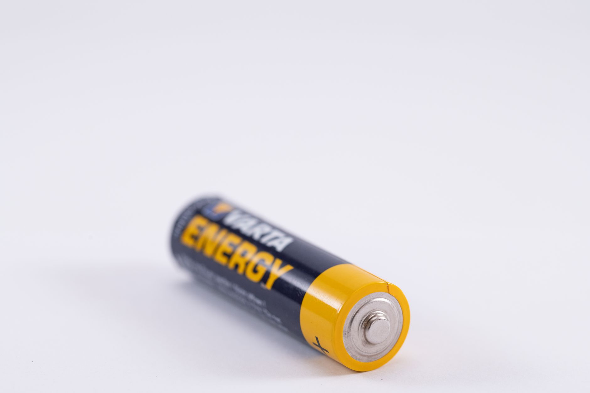 Detailed close-up of a single Varta Energy AA battery on a white background.