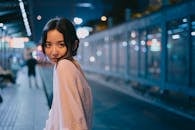Young Asian woman in evening street with bright lights