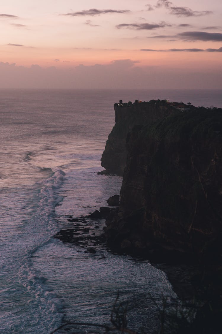 Silhouette Of Mountain Beside Sea During Sunset