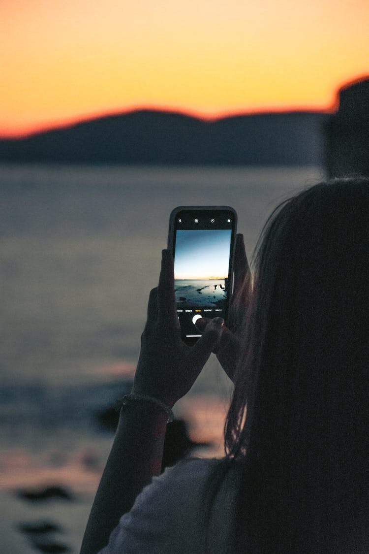 Woman Photographing Sunset