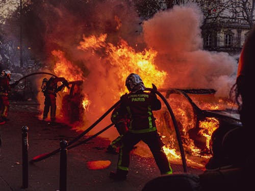 Firemen Extinguishing a Blazing Car Fire