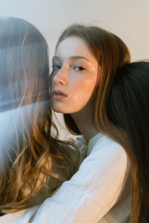 Free Three women embrace softly, reflecting deep connection and empathy. Stock Photo