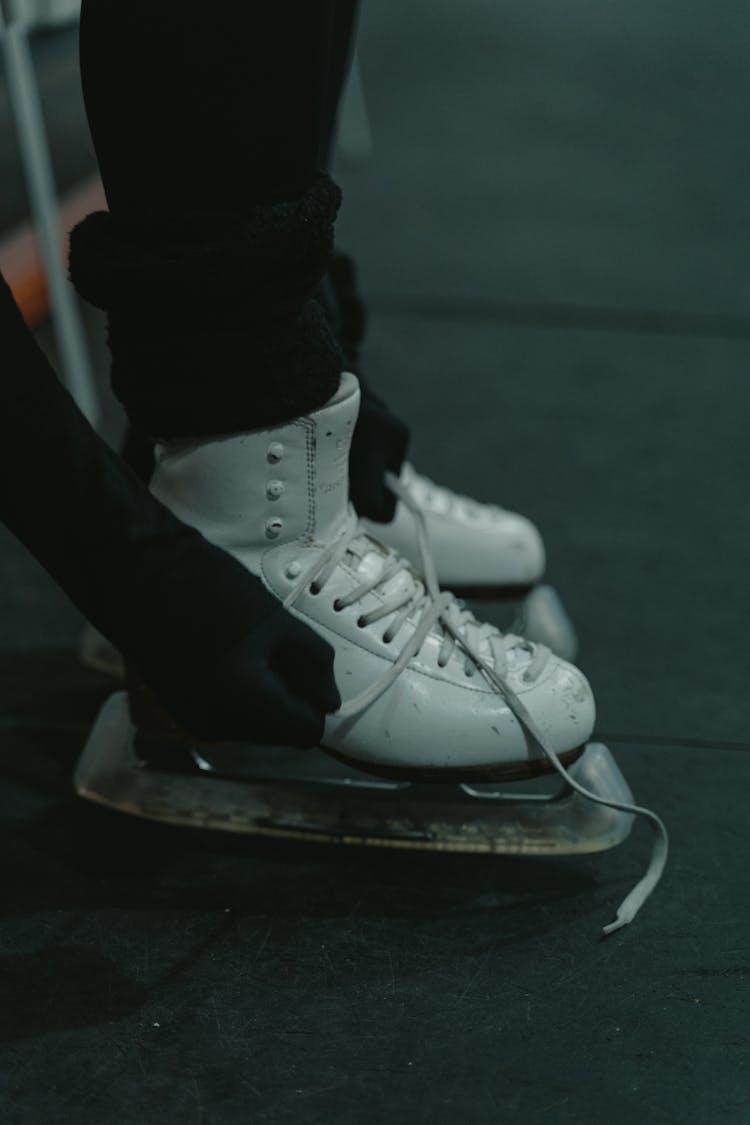 Person Wearing White Ice Skating Shoes 