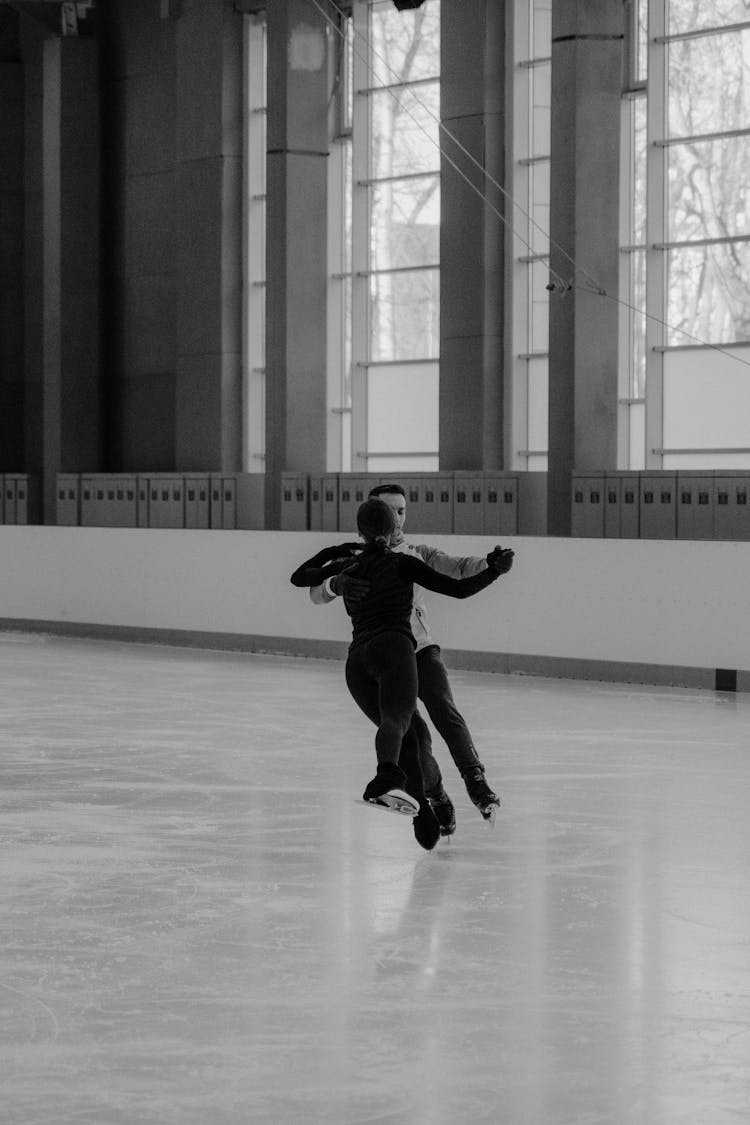 Man And Woman Dancing On Ice Rink