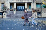 Women Walking on City Street Holding Hands