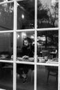 Stylish young man with beard having meal in cafe