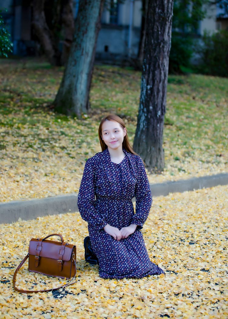 Beautiful Woman Kneel In Autumn Park