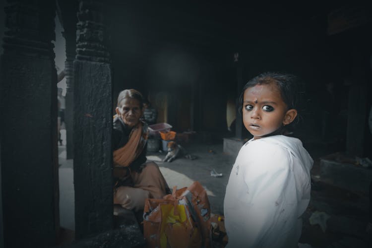 Attentive Indian Girl With Grandmother In Town