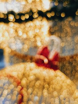 Abstract image featuring bright bokeh lights with a hint of red holiday theme.