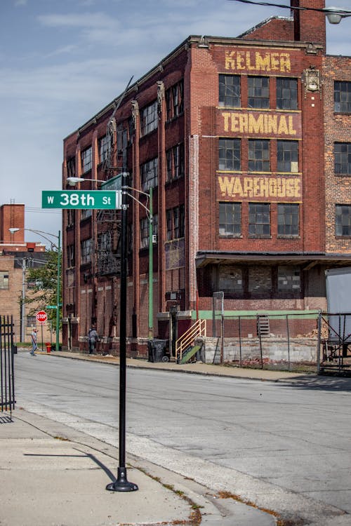 Free Old Brick Warehouse and Empty Street with Sign Stock Photo