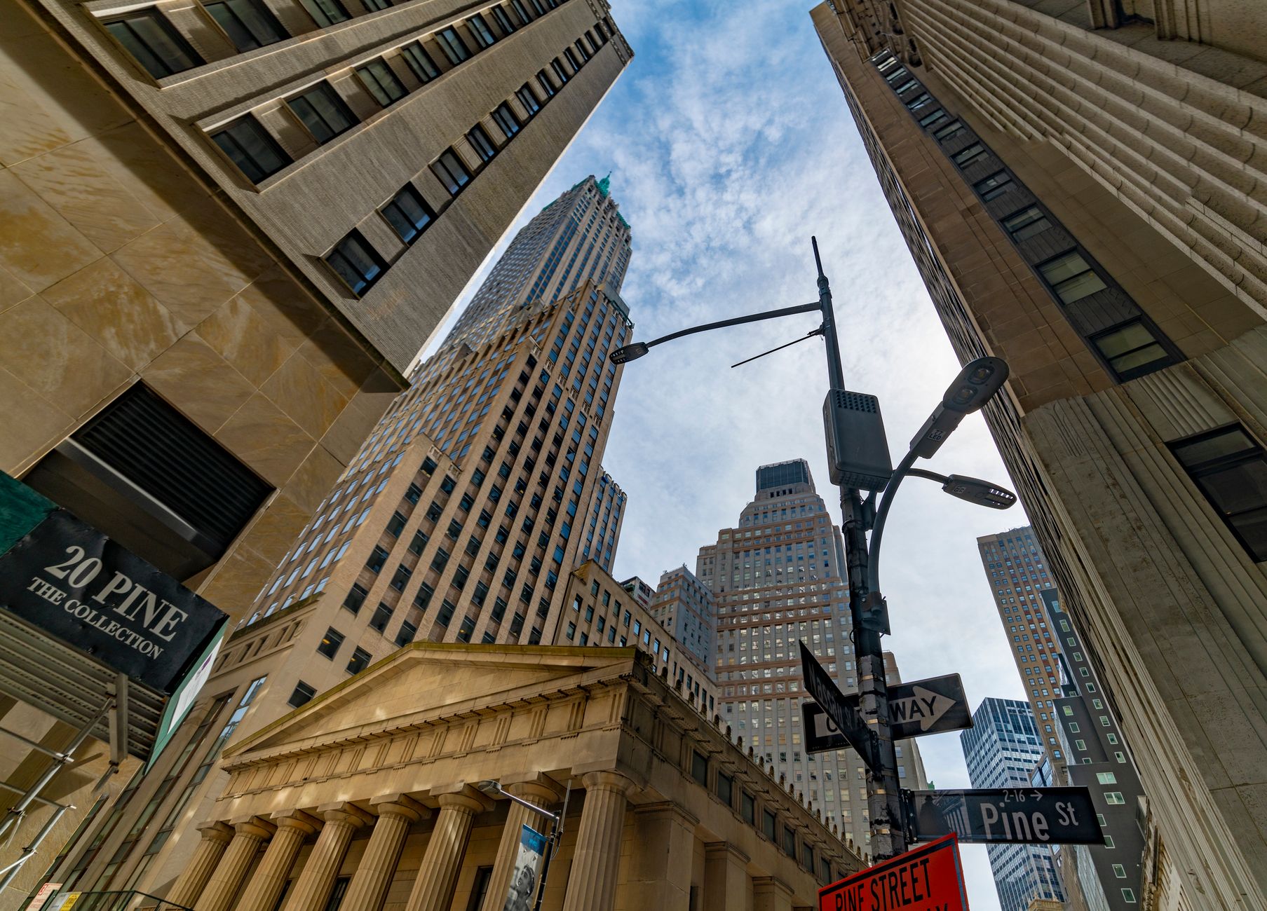 Low-angle view of skyscrapers in New York City's Financial District on a clear day.