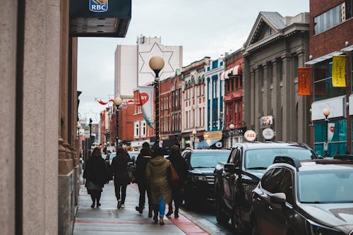 Free People walking on city street in cloudy day Stock Photo