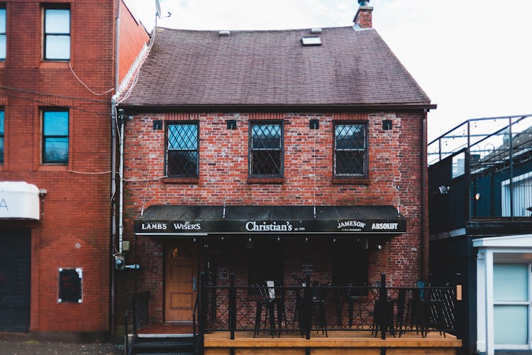 Brick Building Of Bar Under Cloudy Sky In Daytime