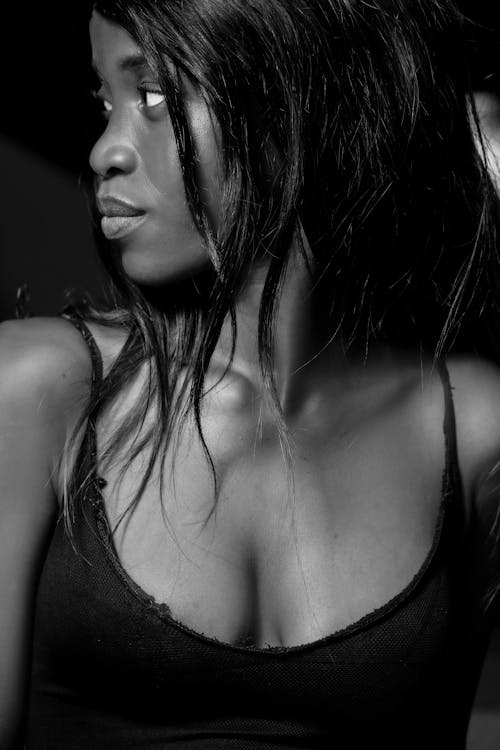 Black woman in dark provocative top