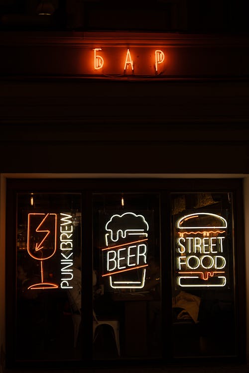 Bar with bright neon signboards on windows
