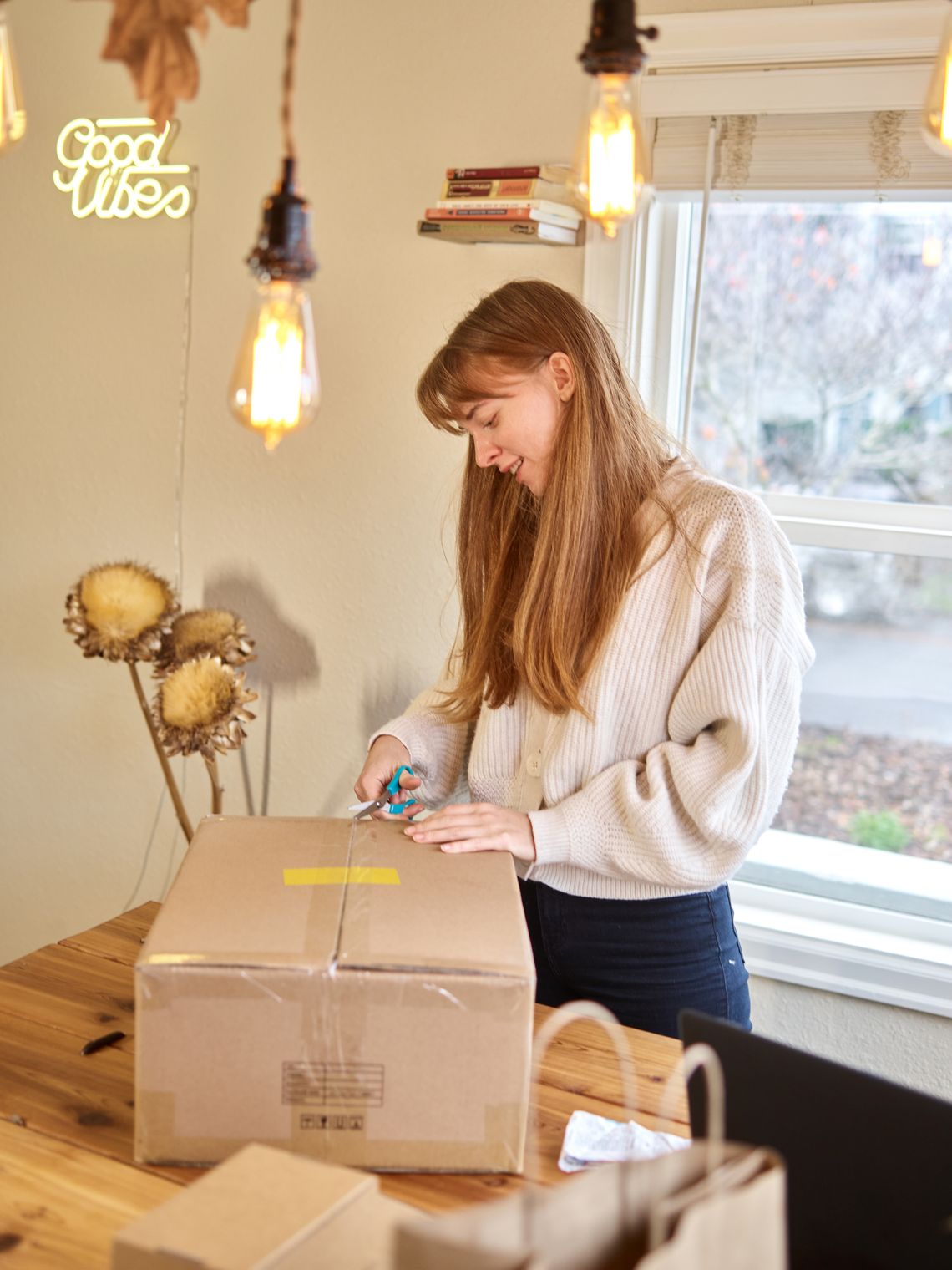 Woman opening a delivery package on a table