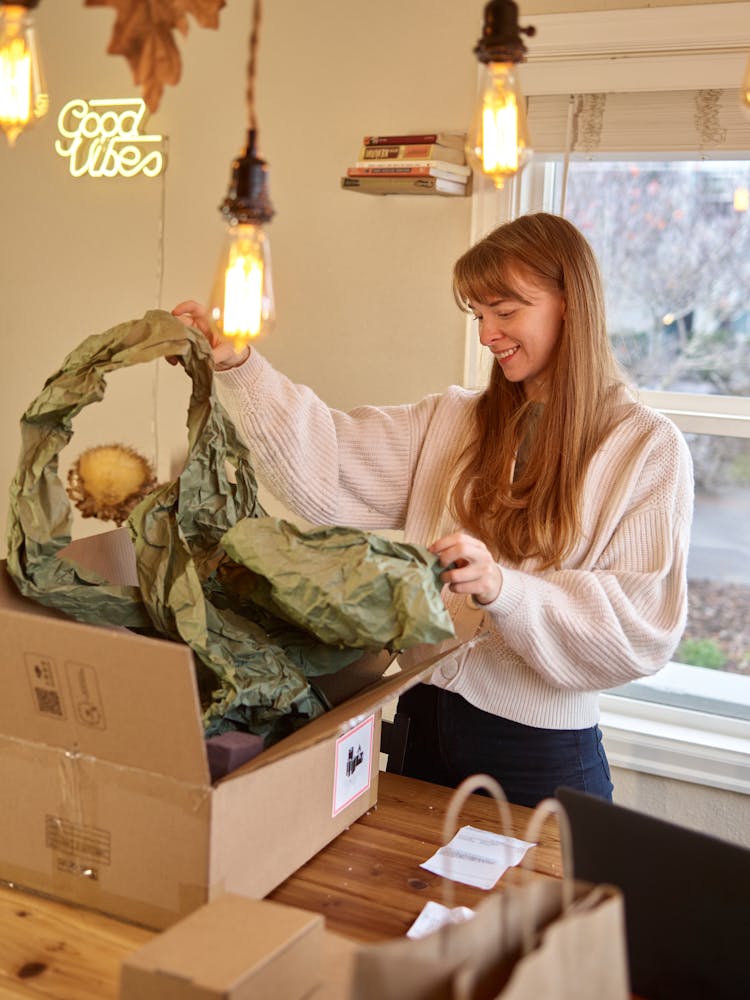 Woman Unpacking Delivery Boxes 