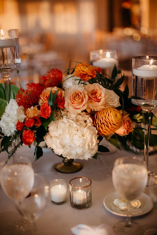 A Beautiful Flower Arrangement Surrounded with Elegant Candles