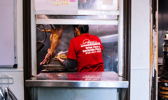 A chef prepares dishes in a kitchen specializing in Mexican cuisine, highlighting street food culture.