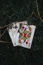 Close-Up Shot of Poker Cards on a Grass