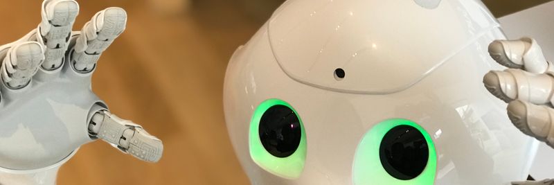 A futuristic humanoid robot with glowing green eyes in a modern setting.