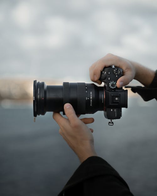 Free Close-Up Shot of a Person Taking Photos Using a DSLR Camera Stock Photo