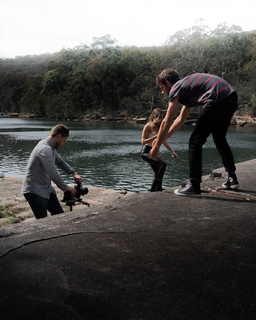 People Filming on the River