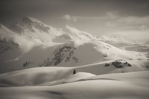 Grayscale Photo of a Snow-Covered Mountain