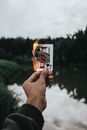 Close-Up Shot of a Person Holding a Burning Poker Card