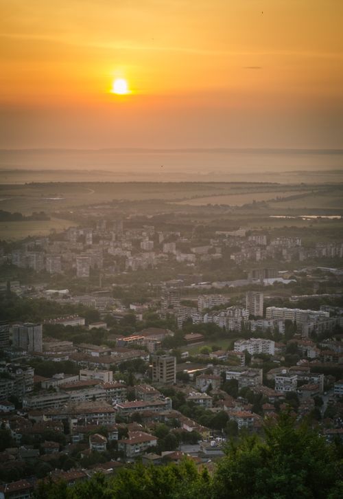 Free Breathtaking aerial view of Shumen, Bulgaria at sunset, capturing the city's urban landscape and vibrant sky. Stock Photo