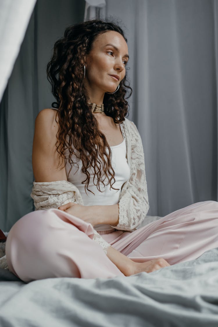 A Woman Sitting On The Bed