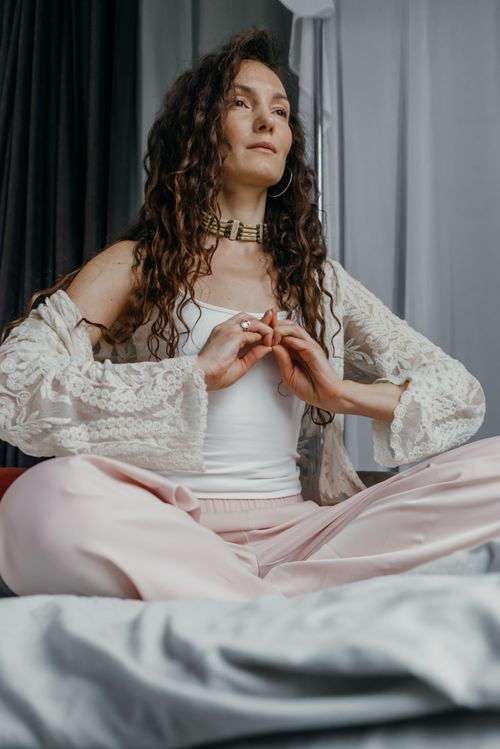 Free A woman practicing yoga indoors, embodying peace and relaxation with a meditative pose. Stock Photo