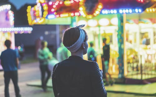 Woman Standing in Front of Carousel