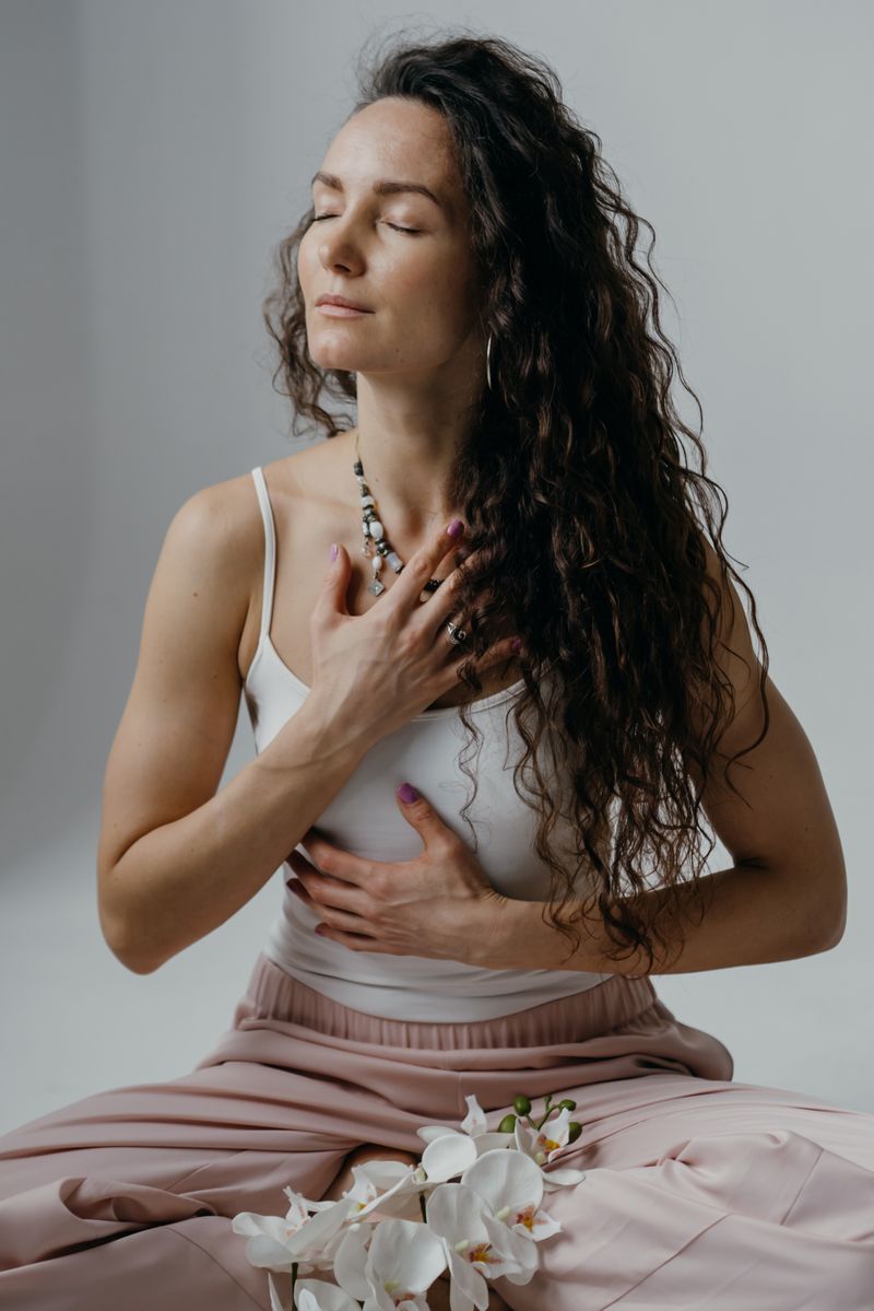 A woman resting her hand on her heart