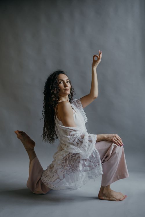 Free Woman performing a yoga pose with a hand mudra, embodying calm and mindfulness. Stock Photo