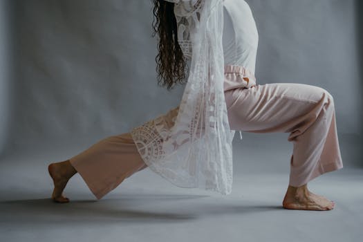 A serene side view of a person performing yoga in a studio, emphasizing grace and focus.