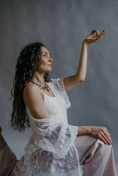 Free A serene woman in a peaceful yoga pose, symbolizing mindfulness and relaxation indoors. Stock Photo
