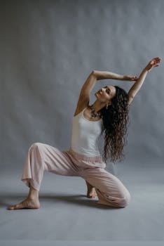 Woman in yoga pose in studio setting, showcasing balance and mindfulness