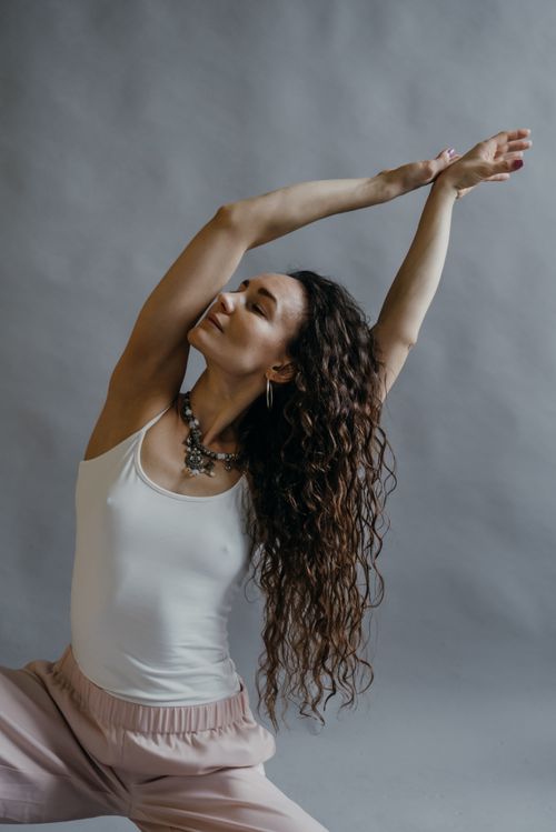 Free A serene moment of a woman practicing a yoga pose indoors, focusing on relaxation and mindfulness. Stock Photo