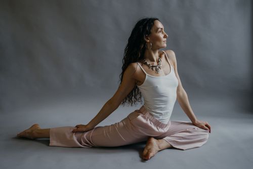 Free A woman practicing a yoga pose in a studio, demonstrating flexibility and wellness. Stock Photo