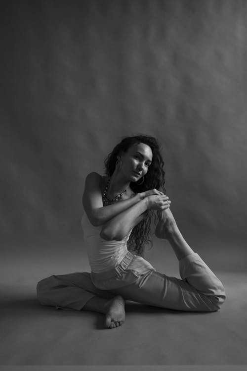 Free Grayscale Photo of Woman in Tank Top Doing Stretching Stock Photo