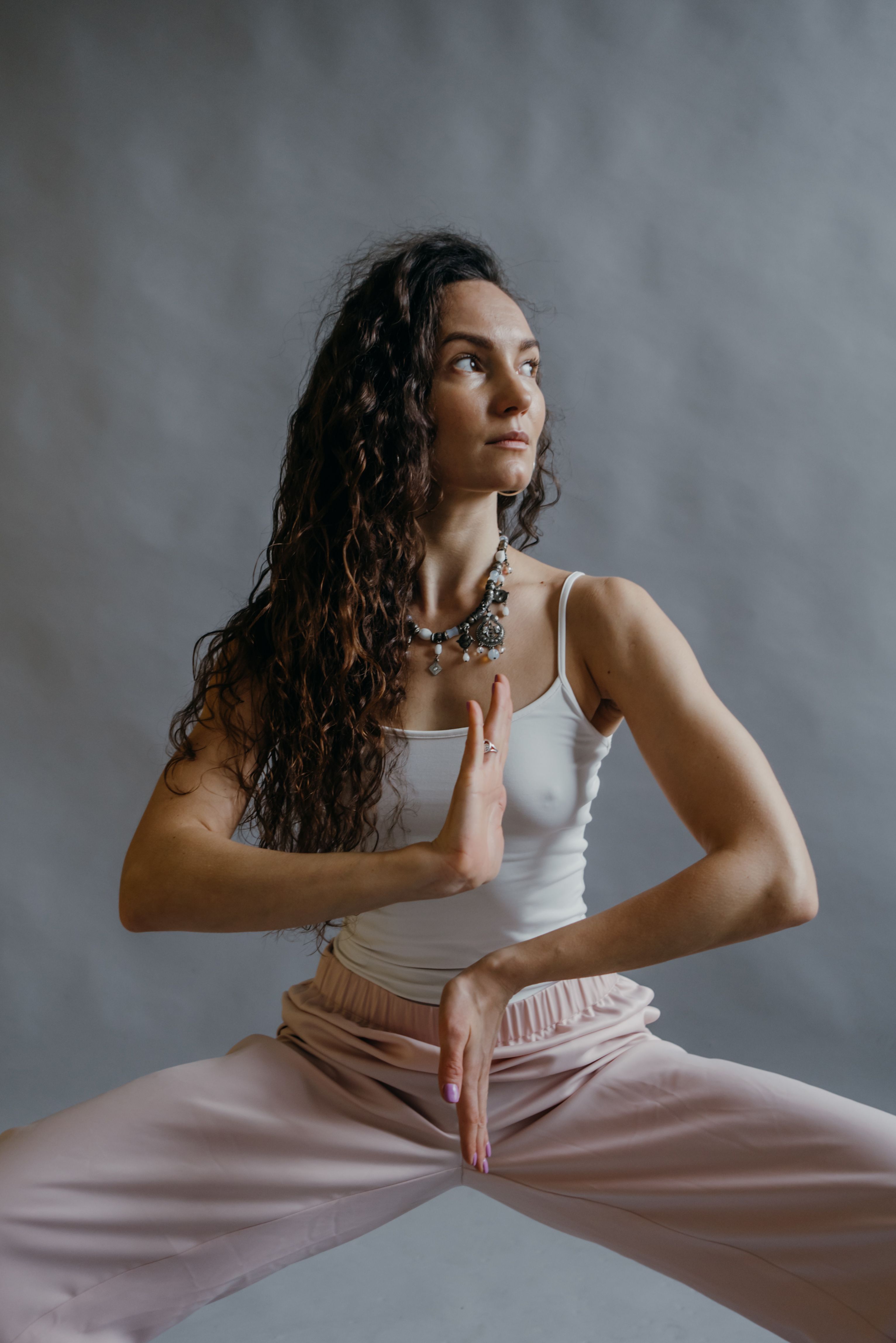 A woman gracefully performs a yoga pose, embodying peace and strength.