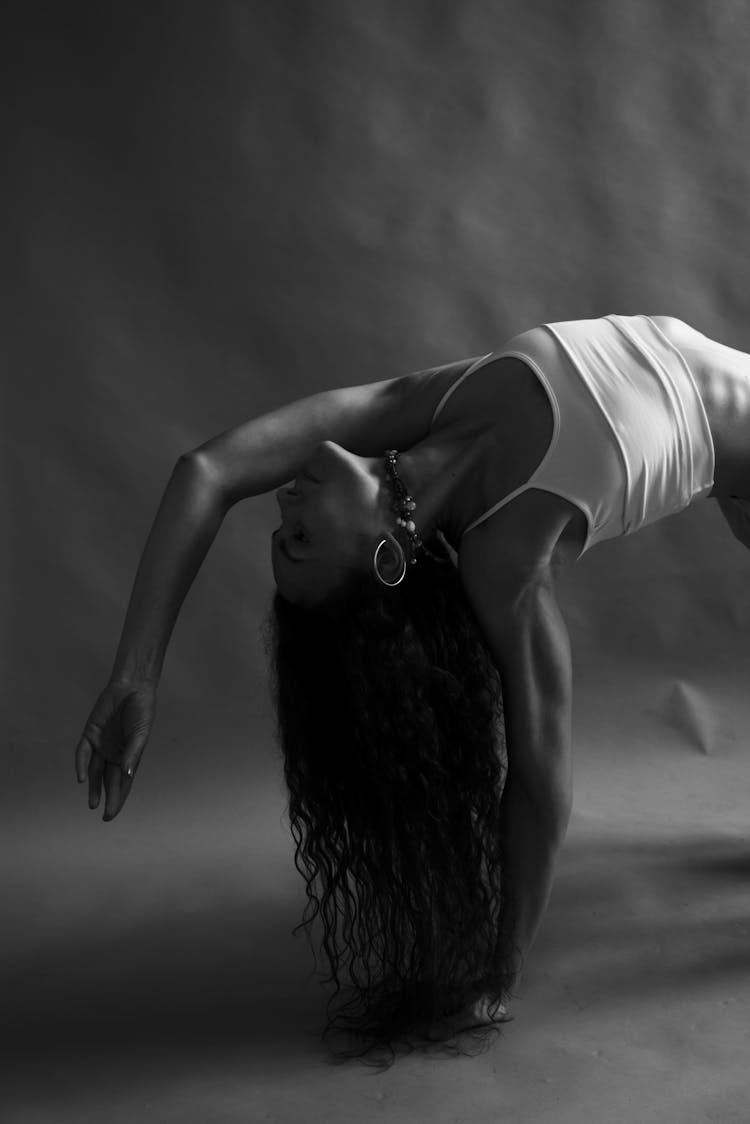 Black And White Photo Of A Woman Bending Backwards